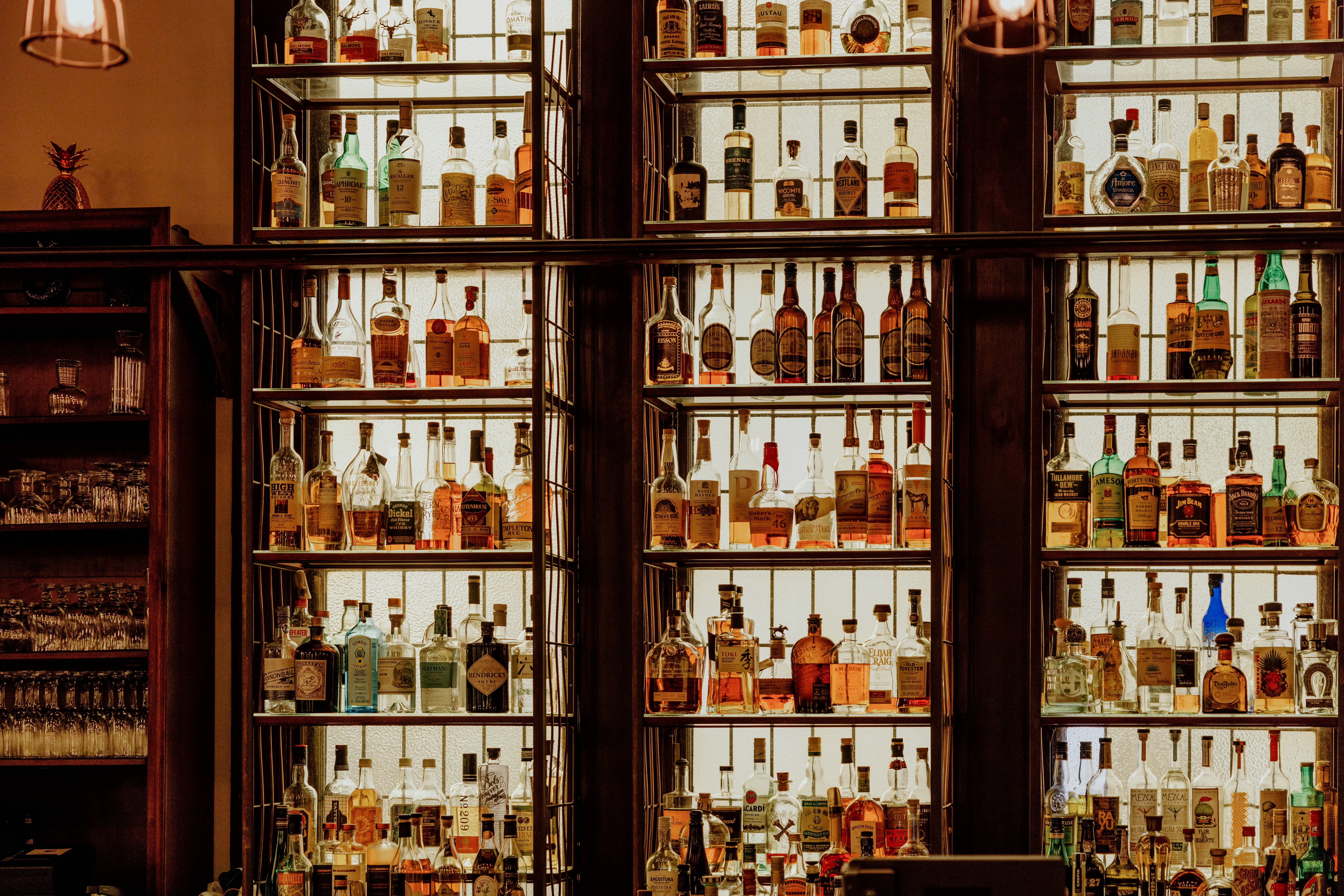 Backlit wall of premium spirits bottles